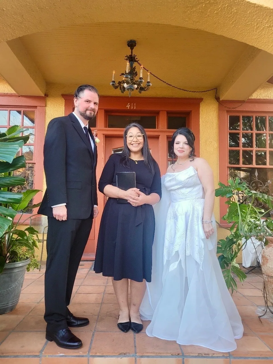 Gloria standing with newlyweds after their wedding ceremony