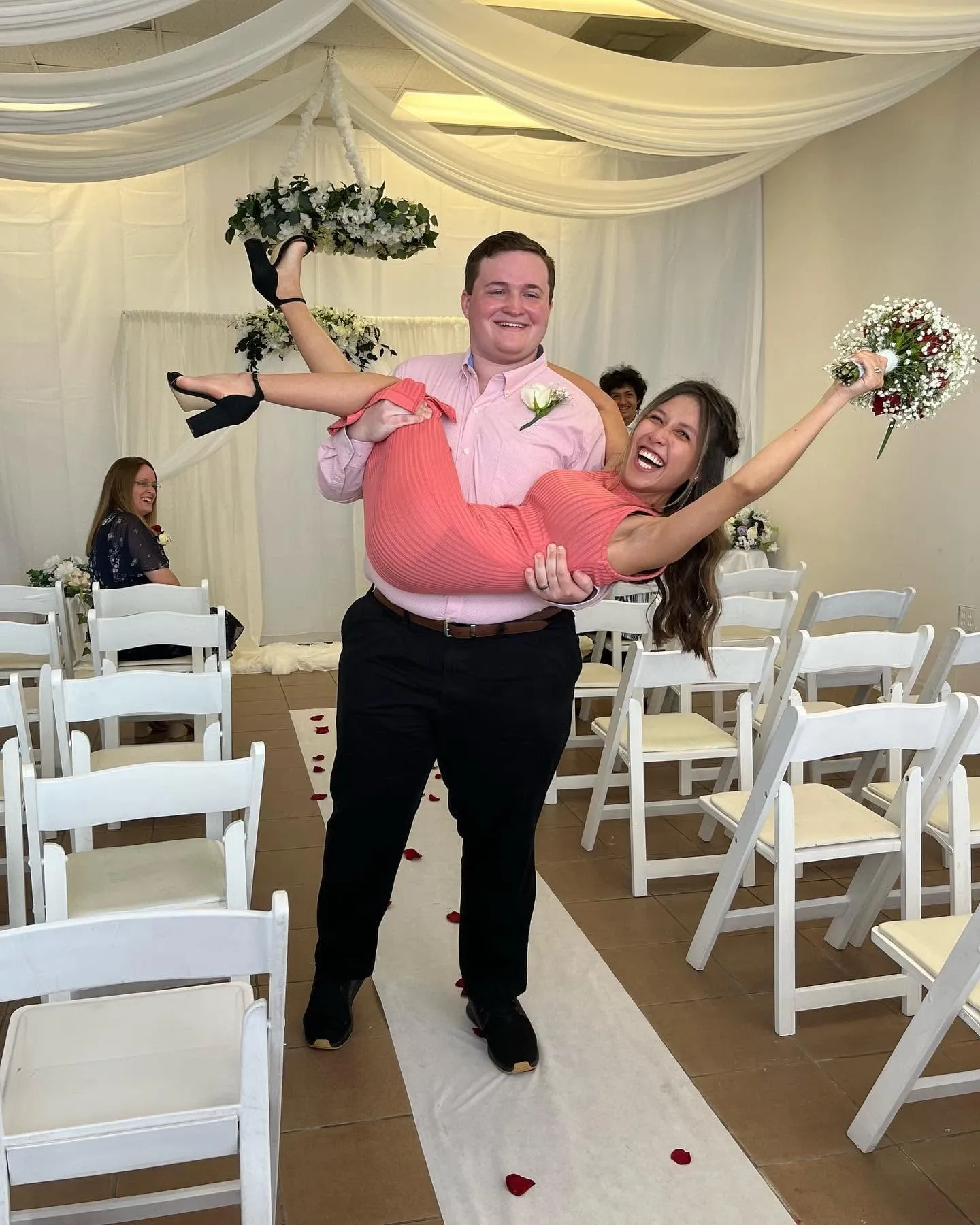 Joyful newlywed couple celebrating in an intimate ceremony room