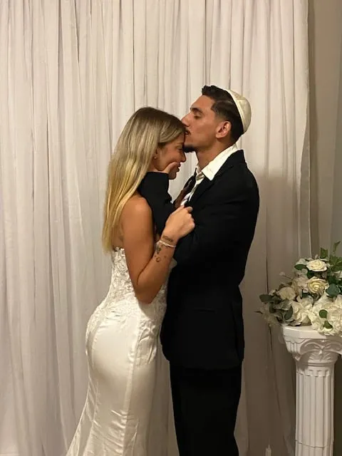 Newlywed couple sharing an affectionate moment after an intimate office ceremony