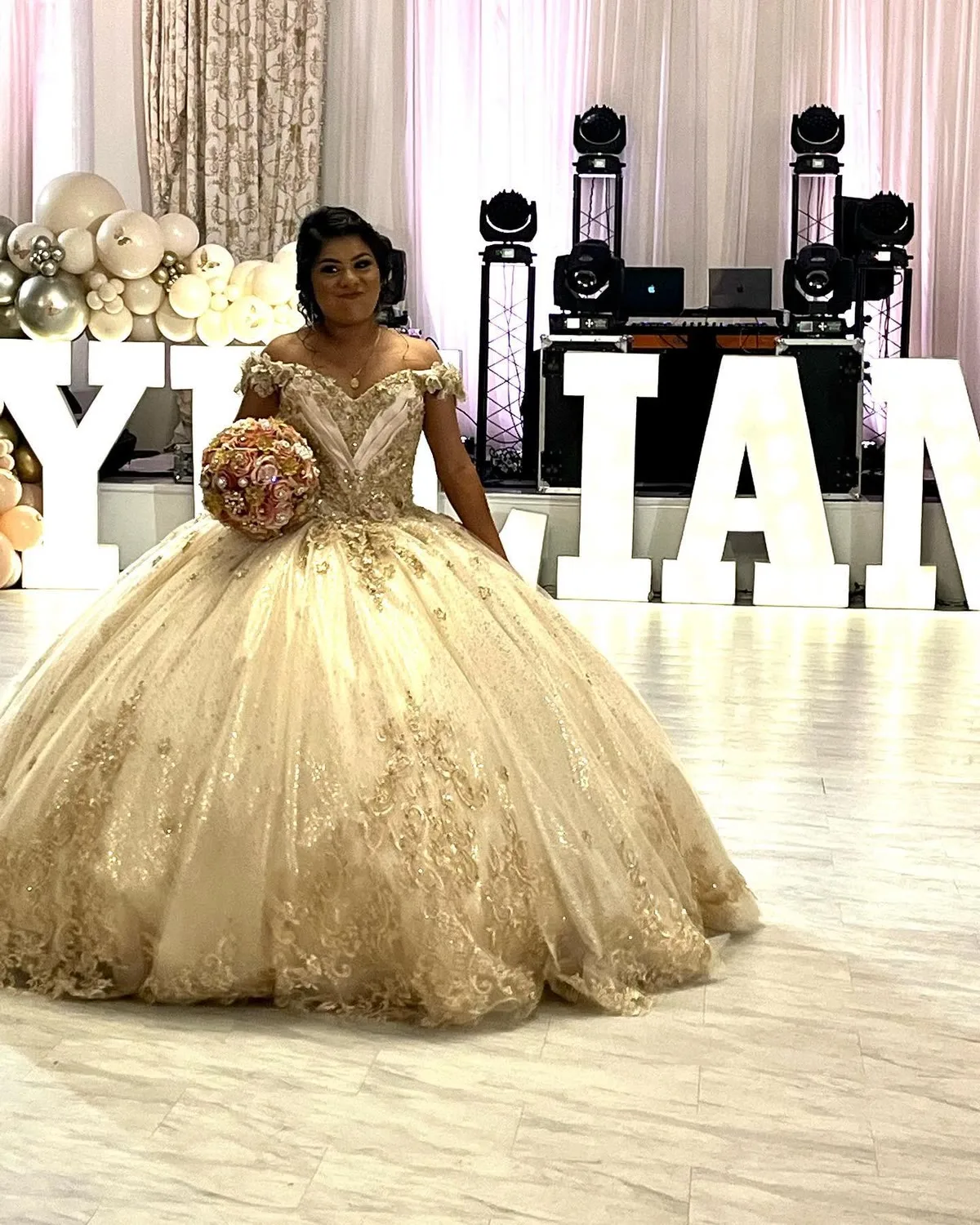 Quinceañera celebrant in a gold gown at her reception